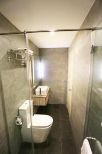 a small bathroom with a toilet and a shower at The Mesui Hotel Bukit Bintang in Kuala Lumpur