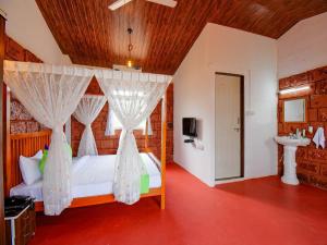 Postel nebo postele na pokoji v ubytování Treebo The Appa'S Resort