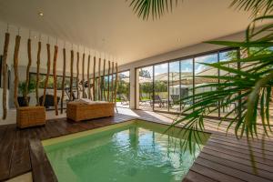 a house with a swimming pool and a patio at La Maison d'Ambrine - La Villa in Chamaret
