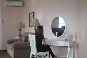 a woman sitting in a chair in front of a mirror at Boulder Dam Hotel in Boulder City