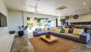 a living room with a couch and a table at Te Ravaki Estate in Rarotonga