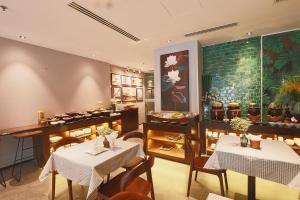 a restaurant with two tables and chairs in a room at CHERRY BOUTIQUE HOTEL in Ho Chi Minh City