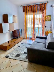 a living room with a couch and a flat screen tv at CASA Di MIRKO in Gallipoli