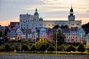 a large white building with two towers on top at Hotel Zamek Centrum in Szczecin