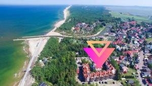 an aerial view of a resort with a pink and orange triangle at Apartamenty Zefir in Rowy