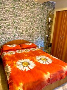 a bedroom with a bed with flowers on it at house in the woods in Reşiţa