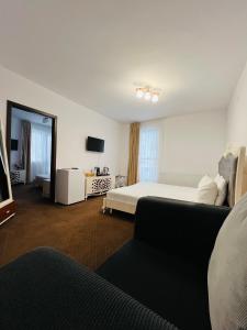 a hotel room with a bed and a couch at Cabana Din Poienita in Poiana Brasov +68 photos