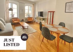 a living room with a table and chairs at Highstatic - Large and Bright 2BR in the nightlife District in Luxembourg