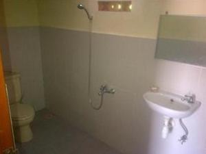 a bathroom with a sink and a toilet at Villa Sinta in Baturiti
