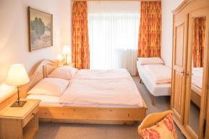 a bedroom with a large bed and a window at Schloss Fürstenstein in Berchtesgaden