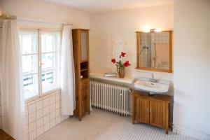 a bathroom with a sink and a mirror and a window at Schloss Fürstenstein in Berchtesgaden +46 photos