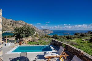 a villa with a swimming pool and a view of the ocean at Villa Nesea Elounda with private pool in Chavgas