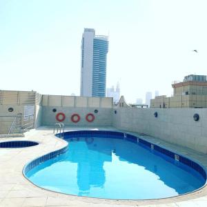 a large swimming pool on the roof of a building at LADIES ONLY-AnaRuby Backpackers - Metro Station Mashreq in Dubai