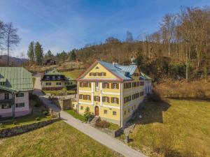 an aerial view of a large yellow house at Schloss Fürstenstein in Berchtesgaden