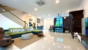 a large living room with a couch and a table at LAVANYA Private Pool Villa Residence 2 Floors @ Pantai Cenang. in Pantai Cenang