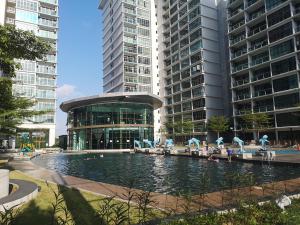 a pool in front of a building with tall buildings at Palazio AegeanSea Homestay By Easyhomestay in Johor Bahru