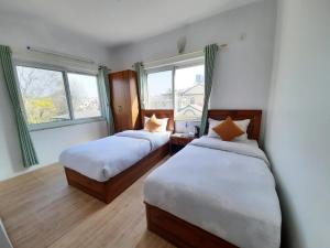 Postel nebo postele na pokoji v ubytování Eco Inn Guest House