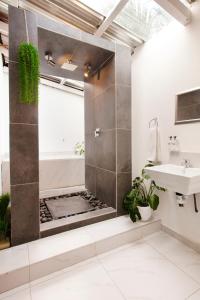 a bathroom with a shower and a sink at Menlyn Apartments in Pretoria