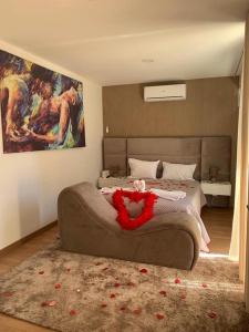 a bedroom with a bed with a heart on it at Hotel Douro Vale de Campos in Penafiel
