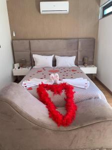 a bedroom with a bed with a red wreath on it at Hotel Douro Vale de Campos in Penafiel