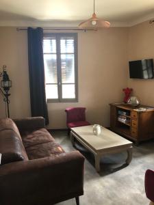 a living room with a couch and a coffee table at Gites de l'aven in Orgnac-lʼAven