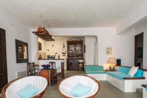 a living room with two chairs and a couch at Golden View Villa in Skiathos