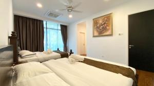 a hotel room with two beds and a window at LAVANYA Private Pool Villa Residence 2 Floors @ Pantai Cenang. in Pantai Cenang +24 photos