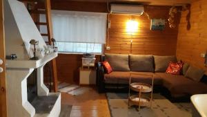 a living room with a couch and a fireplace at Kapteni Holiday House in Paatsalu