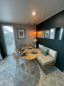 a dining room with a table and a couch at Team Holiday - Camping du Petit Pont in Arvert