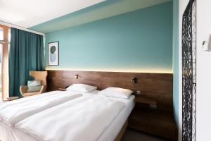 Postel nebo postele na pokoji v ubytování Das Sonnreich - Thermenhotel Loipersdorf