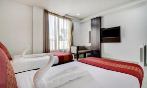 Postel nebo postele na pokoji v ubytování Hotel Raya Inn