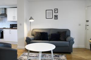 a living room with a couch and a table at Abingdon - Private Flat with Garden & Parking 01 in Abingdon