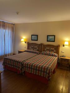 Llit o llits en una habitació de Hotel Garabatos