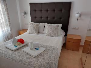 a bedroom with a large bed with two towels on it at Apartamento Nerja Beach in Nerja
