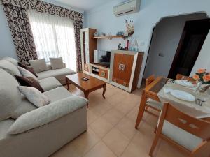 a living room with a couch and a table at Apartamento Nerja Beach in Nerja