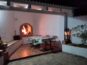 un patio con una mesa y un horno de fuego en One Life Málaga Retreat, en Periana