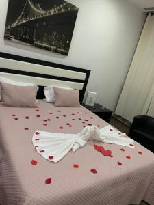 una cama con corazones en ella con una colcha blanca en Hotel Douro Vale de Campos, en Penafiel