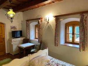 a bedroom with a bed and a desk and a window at Öregház 1839 in Csopak