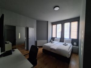 Postel nebo postele na pokoji v ubytování HDC Nivelles Grand-Place