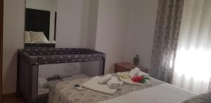 a small bedroom with a bed with a mirror at Apartamento Nerja Beach in Nerja