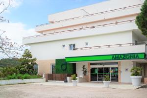 an office building with a green awning at Amazonia Jamor Hotel in Linda-a-Pastora