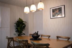 a dining room with a table and chairs and lights at Beecaramulo-Apiturismo in Caramulo