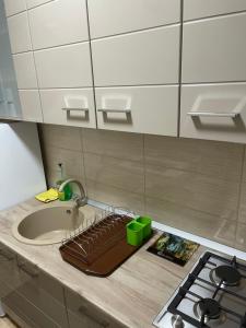 a kitchen counter top with a sink and a sink at ApartElim in Mănăstirea Humorului