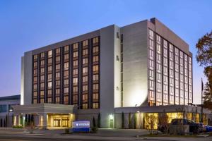a rendering of a hotel building at night at Wyndham Fort Smith City Center in Fort Smith