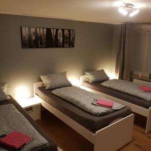two beds in a room with lights on them at Flensburg Zentrum 69 4 in Flensburg