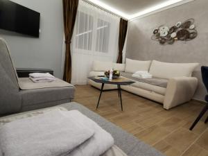 a living room with a couch and a table at Suncana planina apartman 103 in Kopaonik