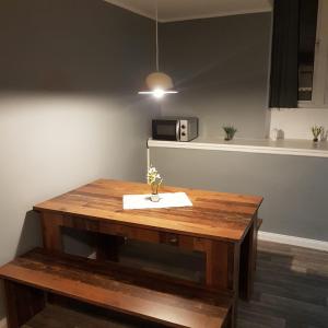 a wooden table in a kitchen with a microwave at Flensburg Zentrum 69 04 in Flensburg