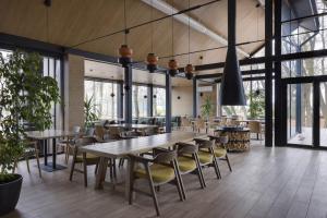 a dining room with a long table and chairs at Hotel Selena Family Resort in Cherkasy