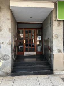 an entrance to a building with glass doors and stairs at Departamento 1 ambiente Excelente ubicación en Mar del Plata in Mar del Plata