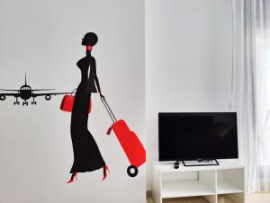 Televízia a/alebo spoločenská miestnosť v ubytovaní CALA ALTA apARTs by RB